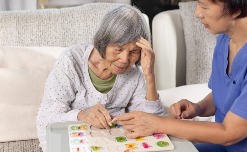 Elderly person and young nurse solving puzzle