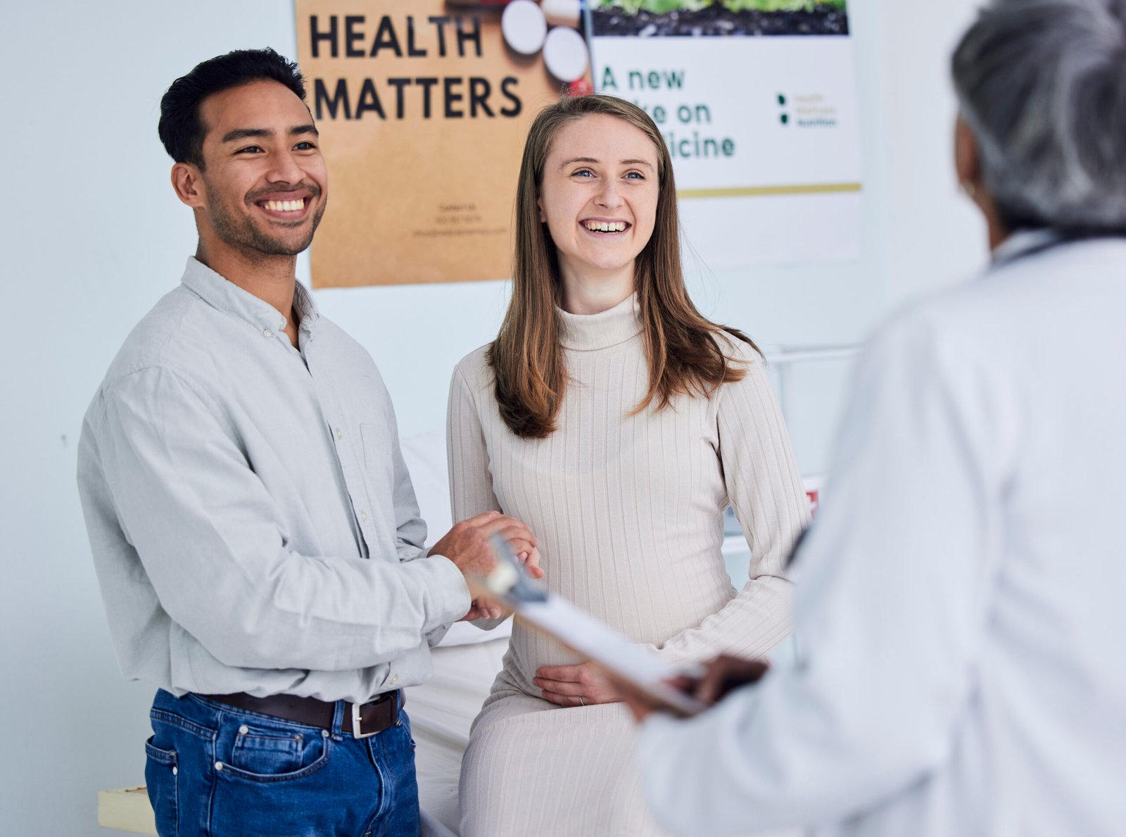 Family, planning and pregnant couple with doctor in consultation office for healthcare exam.